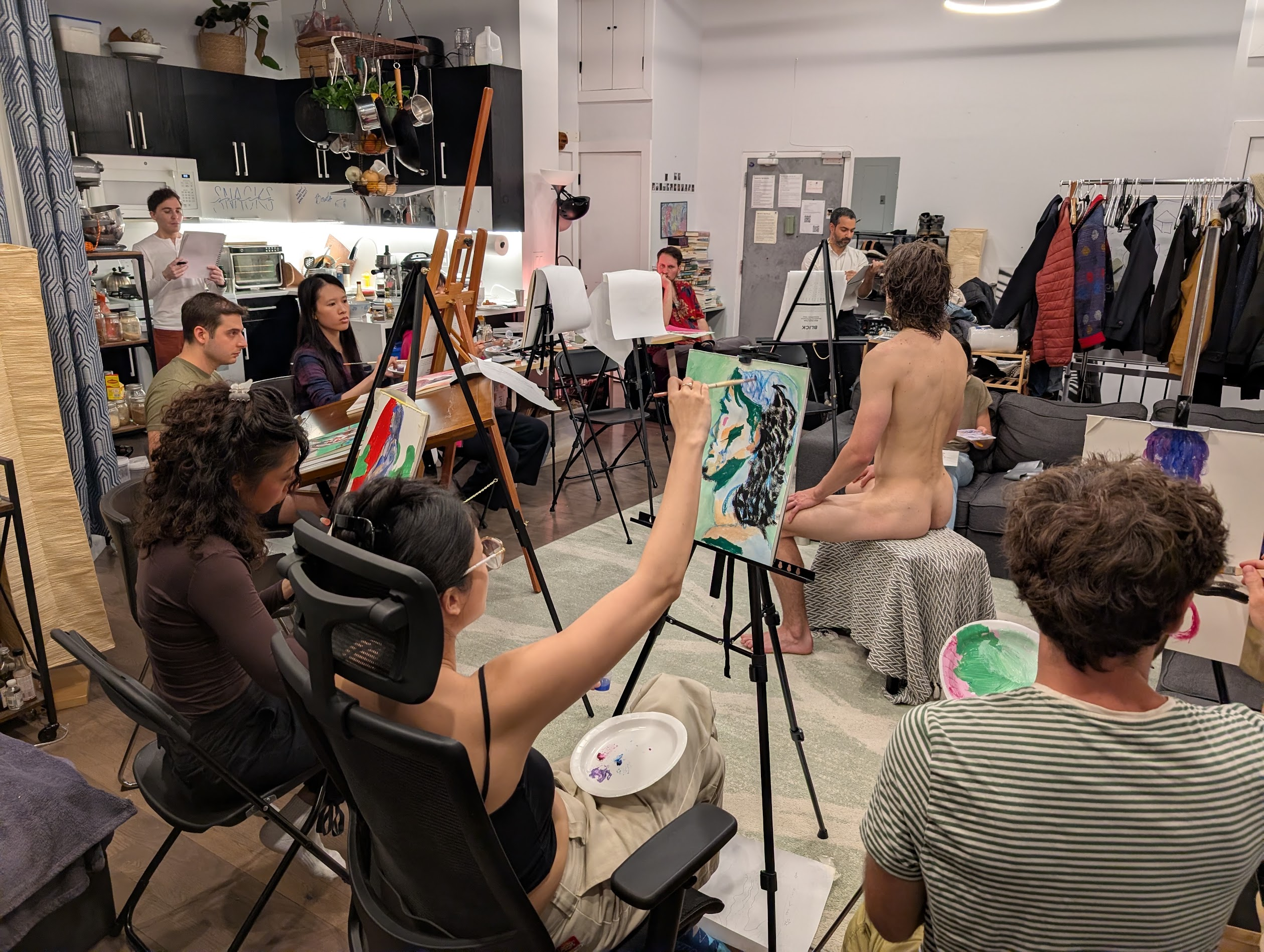 Participants drawing and painting a seated life model during an Art Jam at Merlins Place